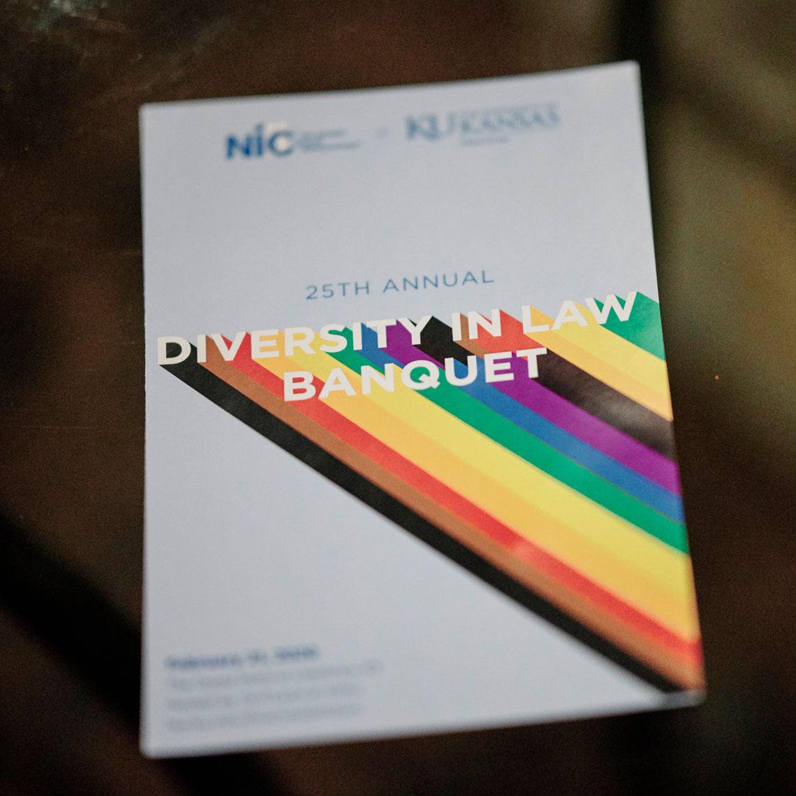 Diversity in Law Banquet program with rainbow design