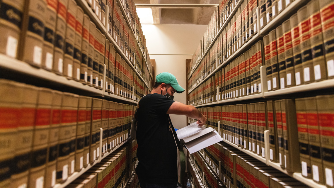 A student looks for a book in the KU Law library