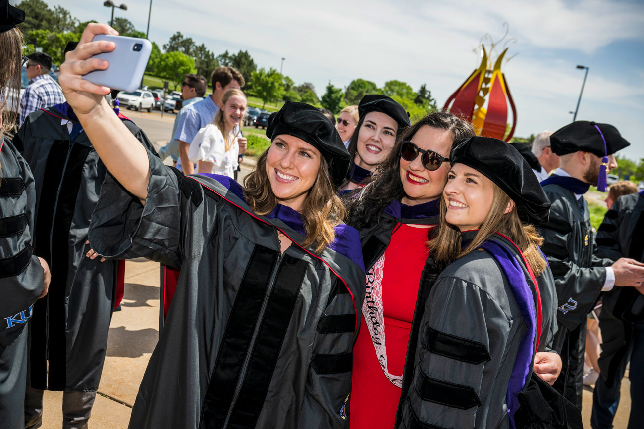 Law students take a picture in graduation regalia