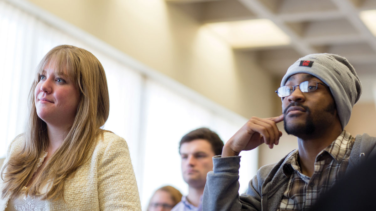 Students listen intently to a presentation