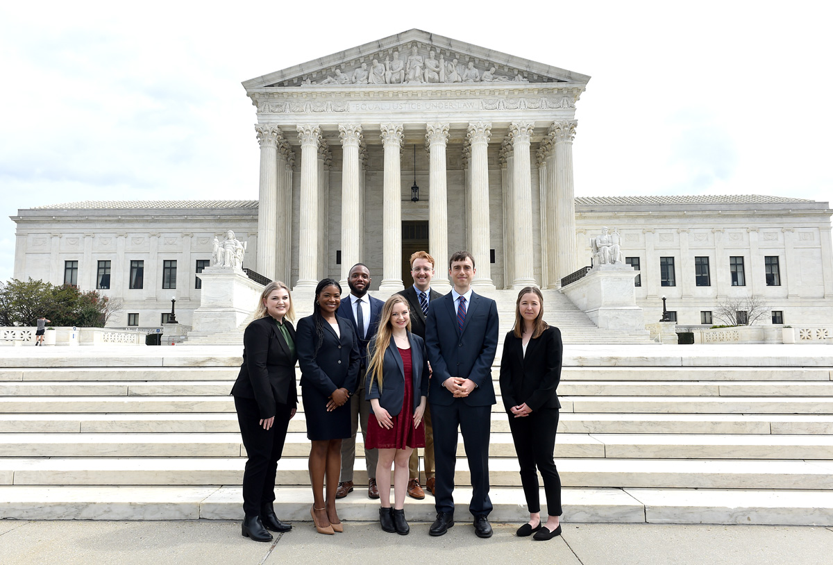 Students in the 6th Semester in DC program pose in front of the Supreme Court of the United States building