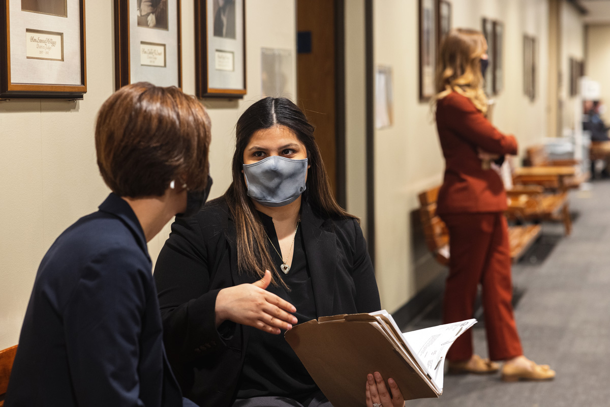A student discusses a case with a professor in the Legal Aid Clinic