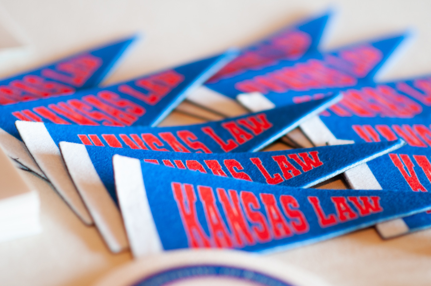 Small Kansas Law pennants on a table at an alumni event