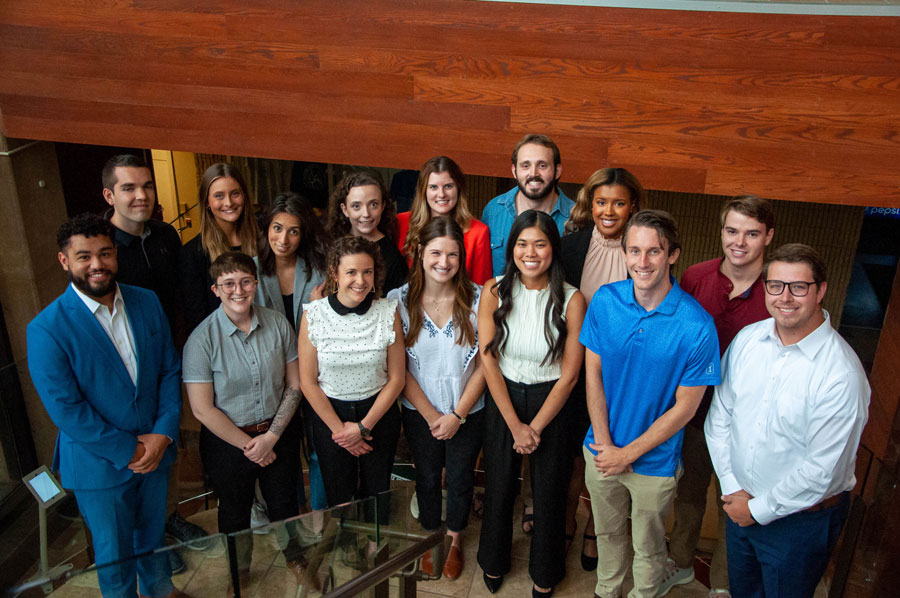 Dean's Fellows stand in a group on the stairs in Green Hall