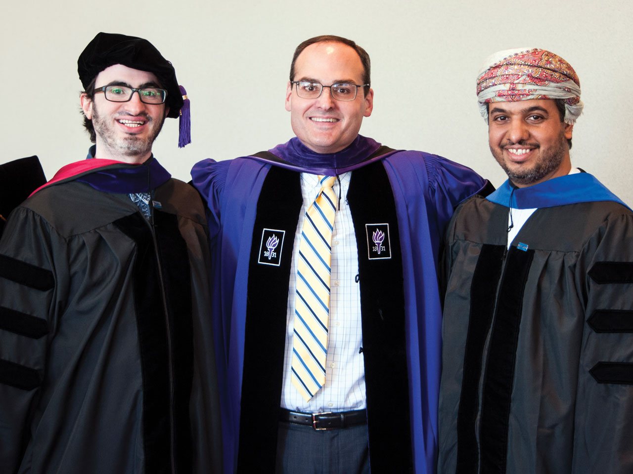 Dean Stephen Mazza, center, with two School of Law alumni.