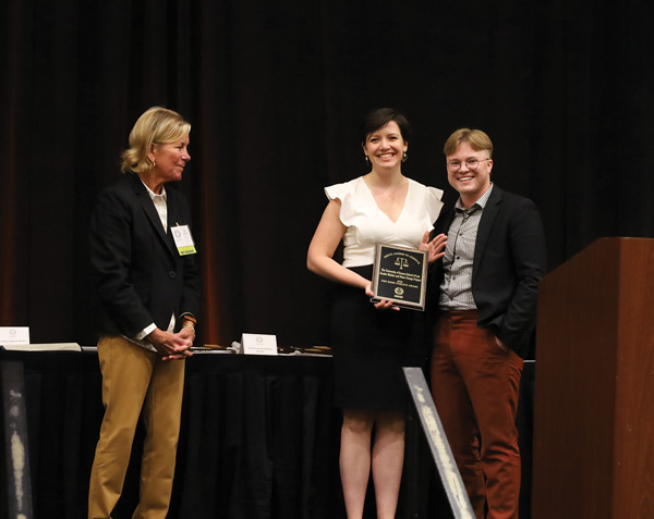 Ellen Bertels, center, and D.C. Hiegert, right, accept a KBA Award for their work on the Gender Marker and Name Change Project. Photo by Corey Shoup, Kansas Bar Association.
