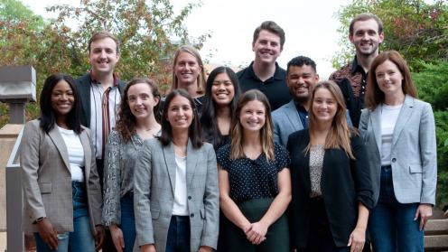 A group of Dean's Fellows poses outside the law school building